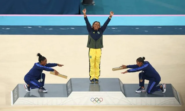 simone biles e jordan chiles reverenciam rebeca andrade no pódio